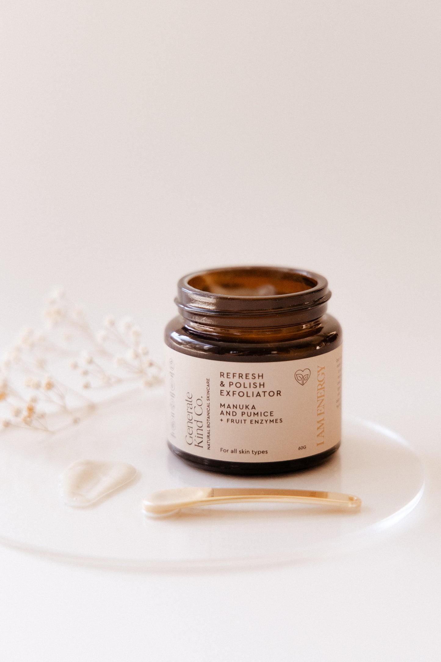 Jar of Generate Kind Co Cream exfoliator product with a golden applicator on a white background