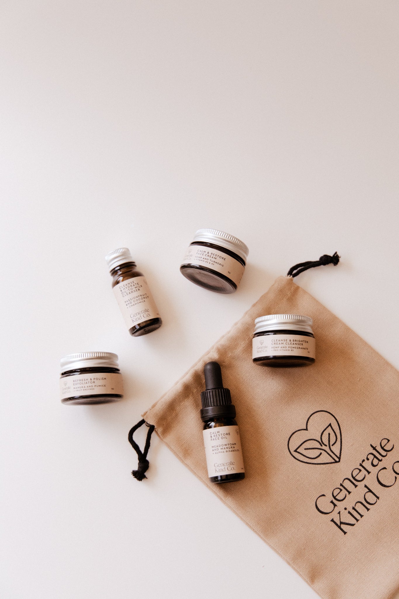 Generate Kind Co. Skincare essentails Sampler Collection products with a branded drawstring bag on a light background
