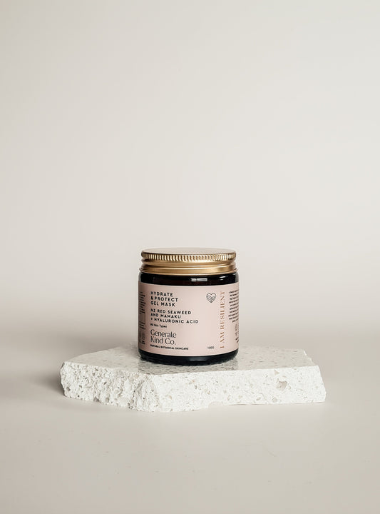 Jar of skincare product on a white surface with a light gray background
