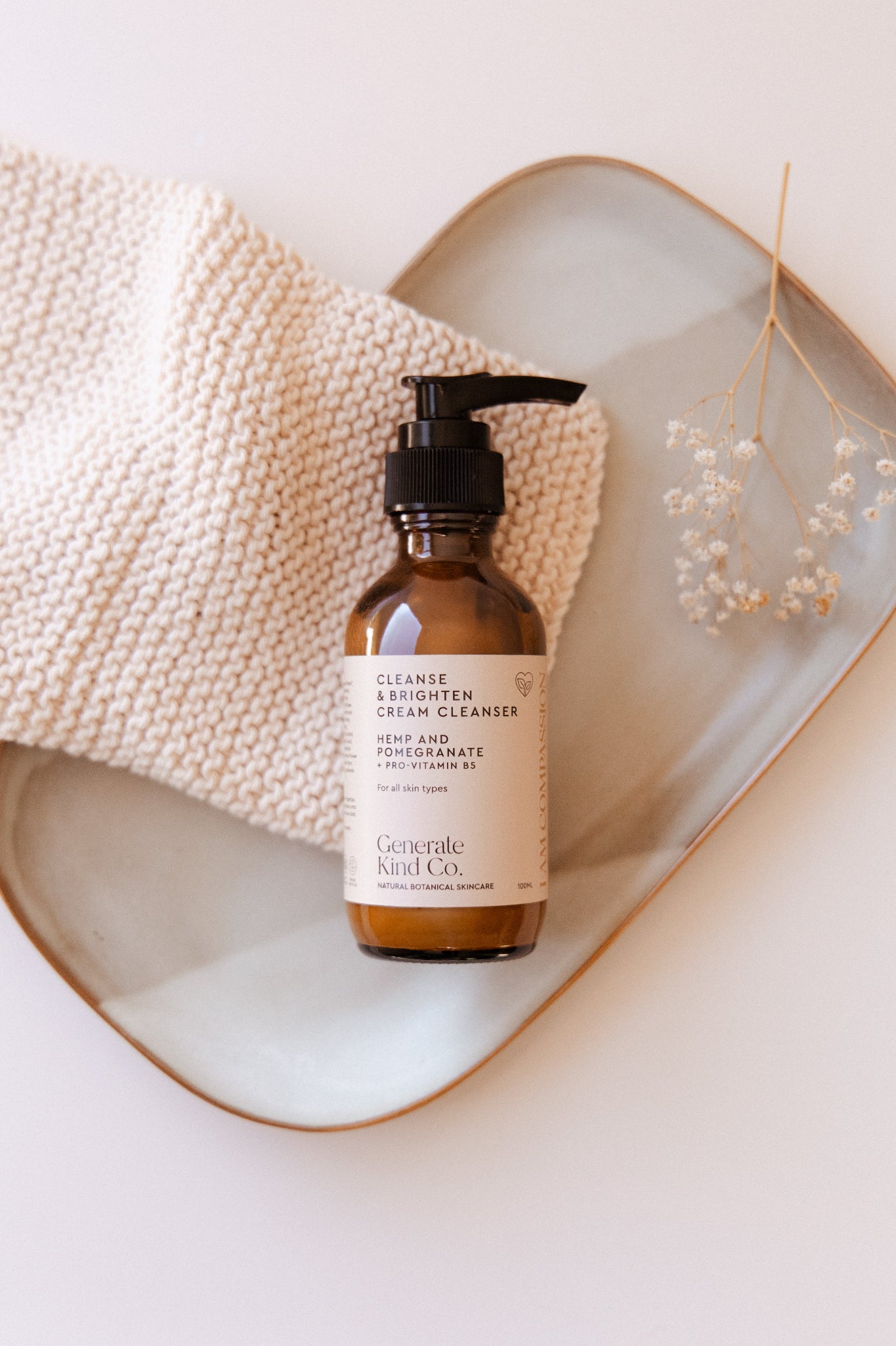 Generate Kind Co cceam Cleanser laying on cotton face cloth with dried botanicals