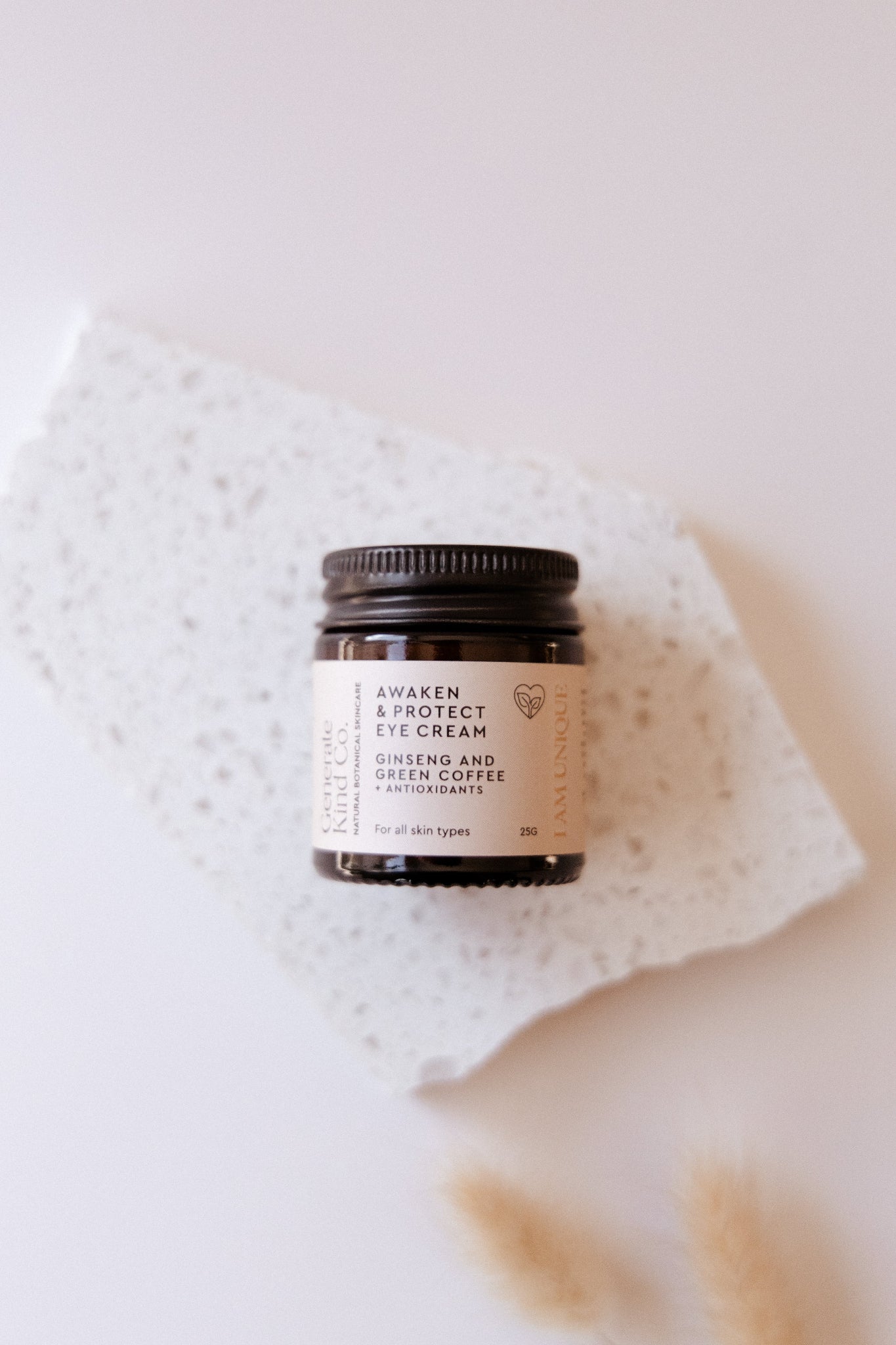 Generate Kind Co Eye cream jar on stone tray