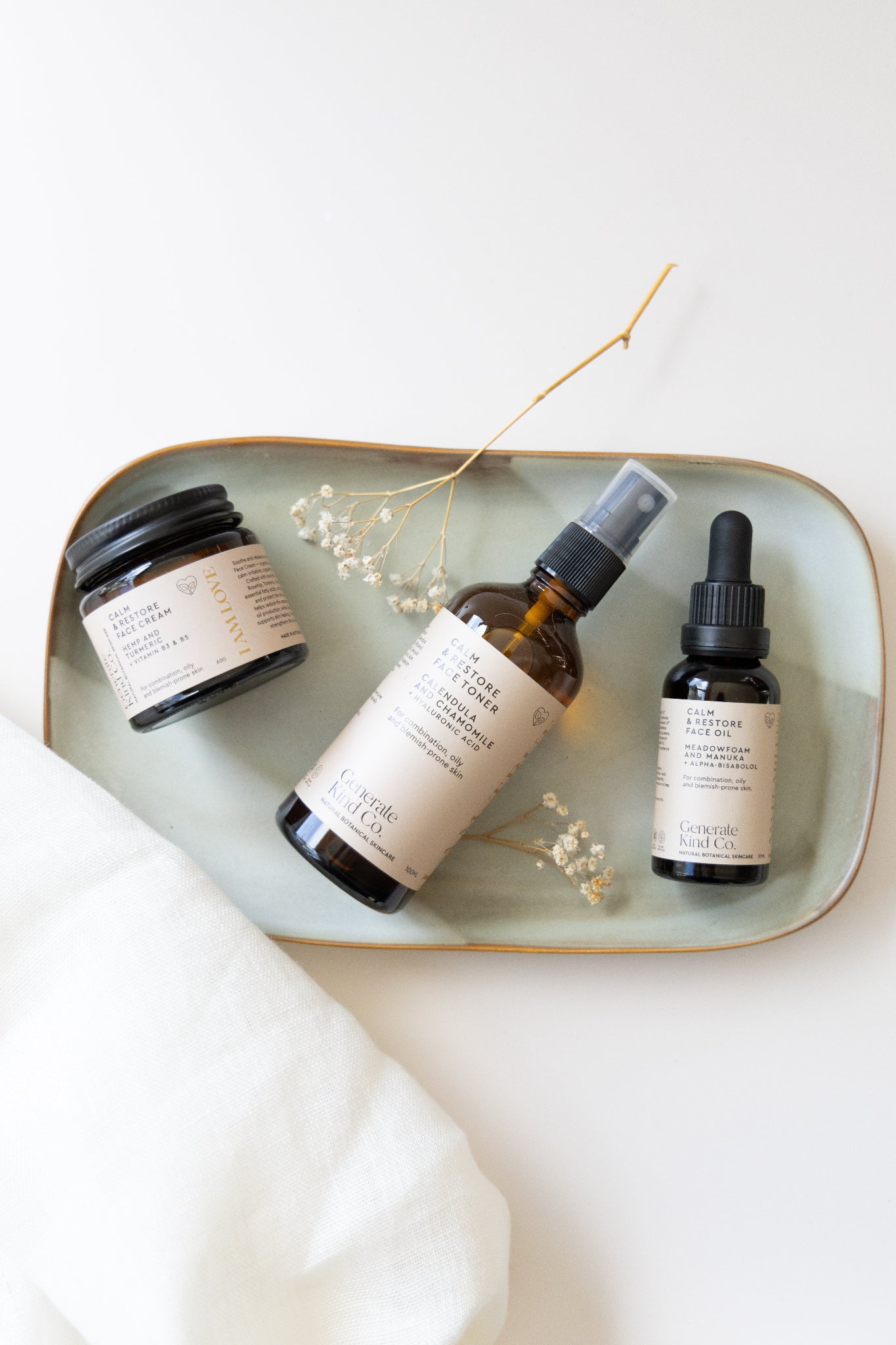 Calm & Restore skincare products on a tray with a white background