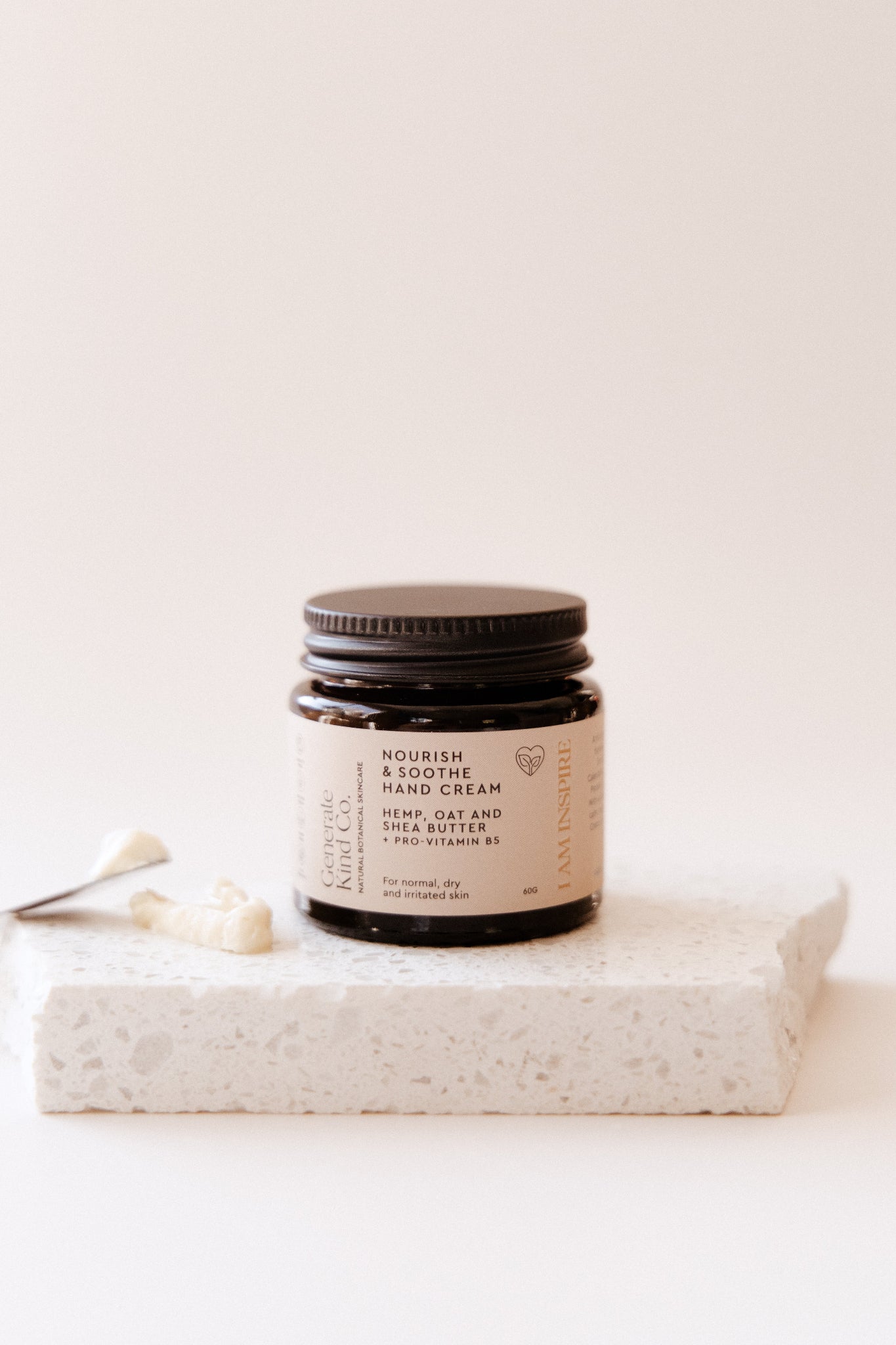 Hand & Body Cream jar on Marble surface with spatula showing Texture