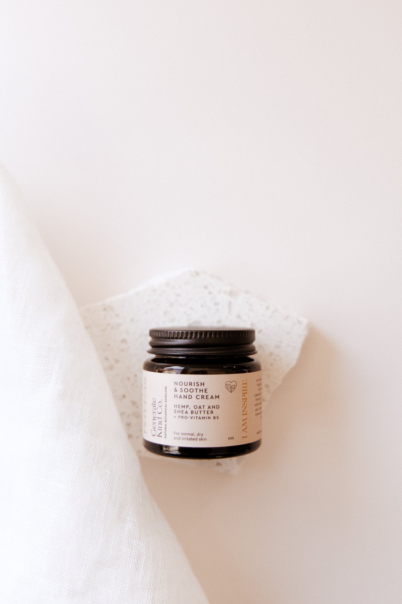 Jar of Hand & Body cream on a white  Marble & Linen background