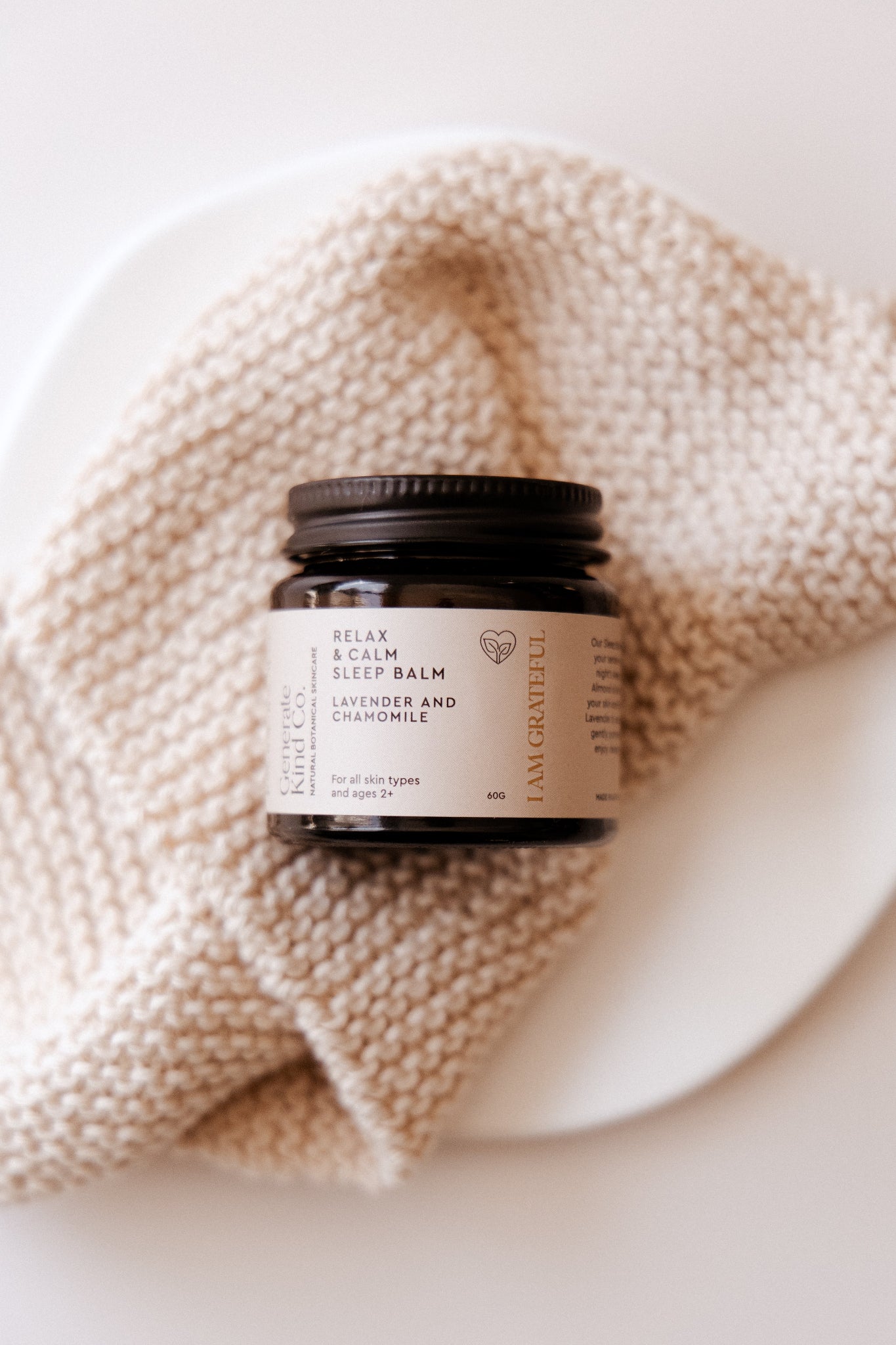Jar of Relax & Calm Sleep Balm on a Knitted Cloth