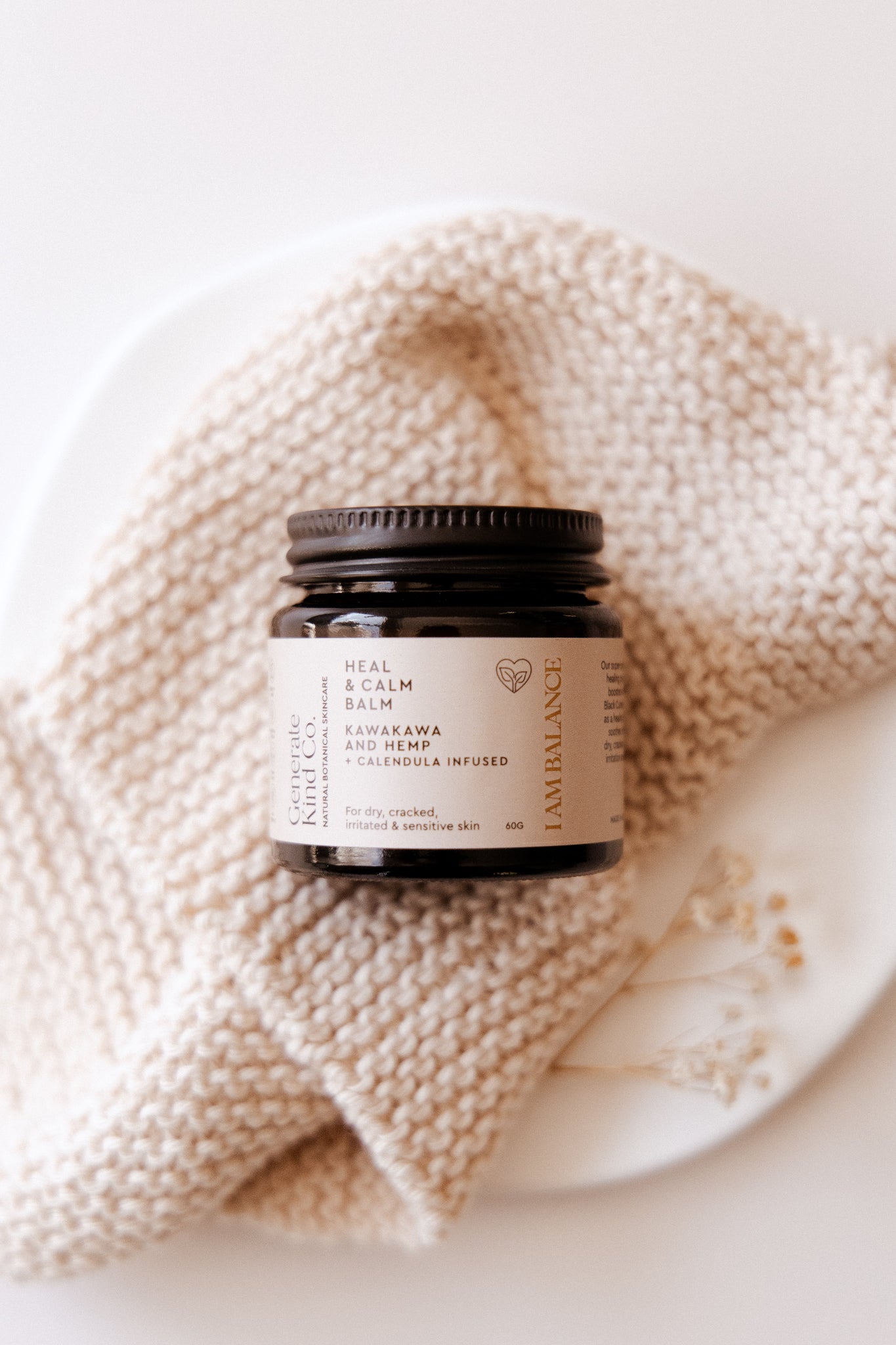 Kawakawa Balm on a textured fabric surface