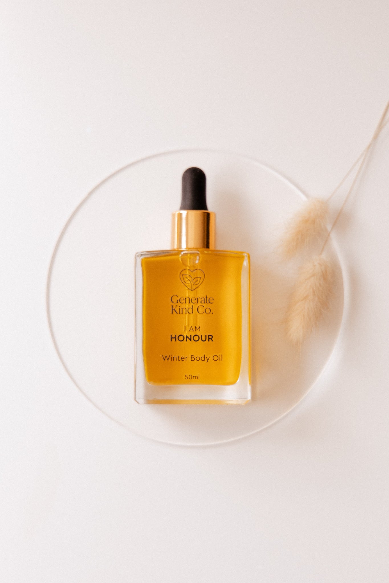Bottle of Winter Body Oil on a plate