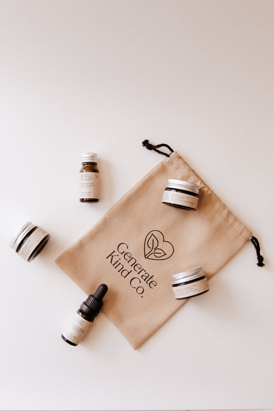 Generate Kind Co. Skincare essentails Sampler Collection products with a branded drawstring bag on a light background