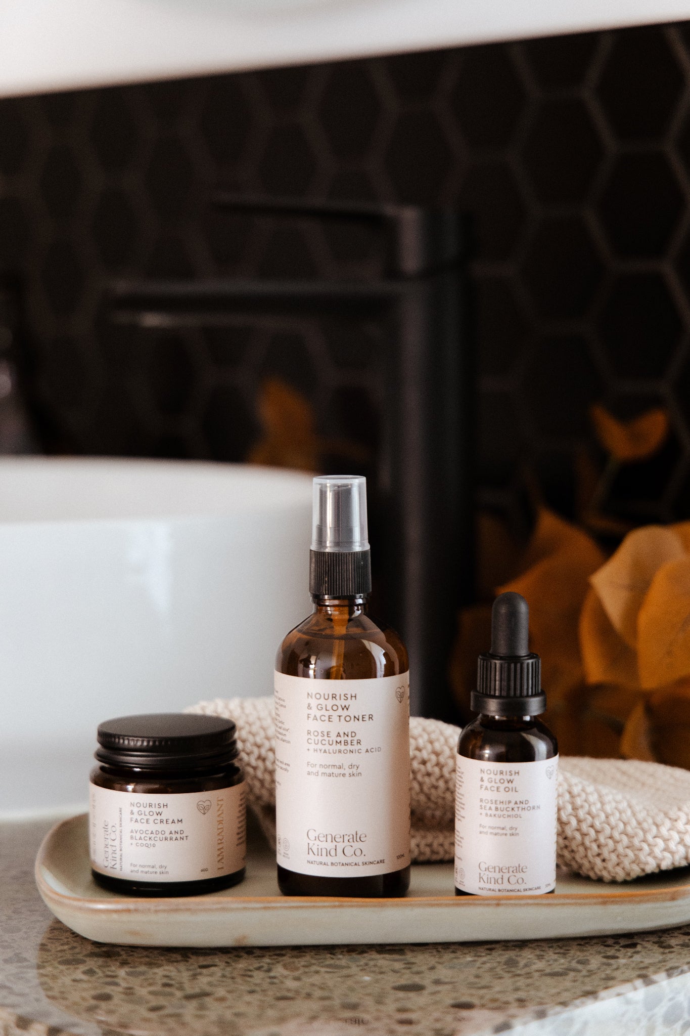 Nourish & Glow skincare range on tray n bathroom